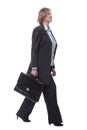 Smiling mature businesswoman walking to side with briefcase Royalty Free Stock Photo