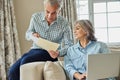 Smiling Mature Couple At Home Reviewing Domestic Finances On Laptop Royalty Free Stock Photo