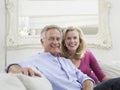 Smiling Mature Couple In White Home Interior