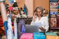 Smiling mature woman at work in her fabric shop Royalty Free Stock Photo