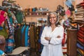 Mature woman smiling while standing in her fabric shop Royalty Free Stock Photo