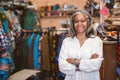 Smiling mature woman standing in her fabric shop Royalty Free Stock Photo