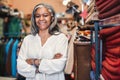 Smiling mature woman standing in her colorful fabric shop Royalty Free Stock Photo