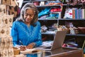Mature woman working at a counter in her fabric shop Royalty Free Stock Photo