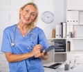 Female doctor writing notes on clipboard in clinic Royalty Free Stock Photo