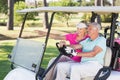 Smiling mature golfer woman showing to man Royalty Free Stock Photo