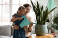 Smiling mature grandmother teaching little granddaughter to watering plant Royalty Free Stock Photo