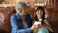 Loving grandmother congratulate excited little granddaughter with birthday