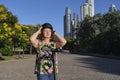 Smiling mature latin woman putting on a helmet to ride her electric kick scooter Royalty Free Stock Photo