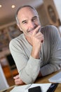 Smiling mature man sitting at desk Royalty Free Stock Photo