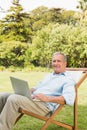 Smiling mature man using laptop Royalty Free Stock Photo