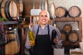 Smiling mature man working on cork bottle device Royalty Free Stock Photo