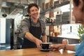 Waiter serving coffee to customer Royalty Free Stock Photo