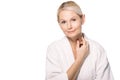 smiling mature woman in bath robe touching neck Royalty Free Stock Photo