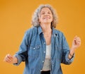 Smiling mature woman celebrating, dancing and being carefree, happy and excited for retirement. Portrait of positive Royalty Free Stock Photo