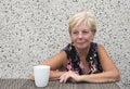 Smiling mature woman with coffee with copy space Royalty Free Stock Photo