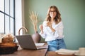 Smiling mature woman drinking her coffee in the kitchen at home Royalty Free Stock Photo