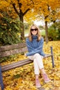 Smiling mature woman enjoying fall weather in the park Royalty Free Stock Photo