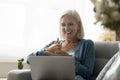 Mature woman with hearing impairment take part in virtual meeting