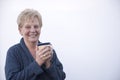 Smiling mature woman holding a cup of coffee Royalty Free Stock Photo