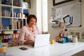 Smiling Mature Woman With Laptop Working In Home Office