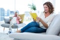 Smiling mature woman reading book at home Royalty Free Stock Photo