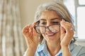 Smiling Mature Woman Trying On New Glasses At Home