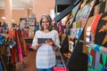 Smiling mature woman using a tablet in her textiles shop Royalty Free Stock Photo