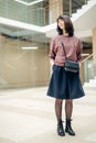 Mature woman walking confidently in mall while looking at camera Royalty Free Stock Photo