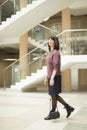 Mature woman walking confidently in mall while looking at camera Royalty Free Stock Photo