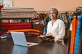 Smiling mature woman at work in her colorful fabric store Royalty Free Stock Photo