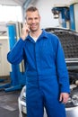 Smiling mechanic on the phone Royalty Free Stock Photo