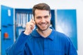 Smiling mechanic on the phone Royalty Free Stock Photo