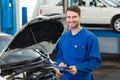 Smiling mechanic using a tablet pc