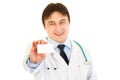 Smiling medical doctor holding blank business card Royalty Free Stock Photo