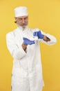 Old doctor standing in a white uniform Royalty Free Stock Photo