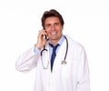 Smiling medical doctor speaking on cellphone Royalty Free Stock Photo