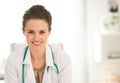 Smiling medical doctor woman sitting in office Royalty Free Stock Photo