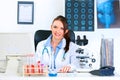 Smiling medical doctor woman sitting at table Royalty Free Stock Photo