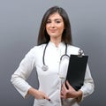 Smiling medical doctor woman with stethoscope against gray background Royalty Free Stock Photo