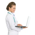 Smiling medical doctor woman working on laptop Royalty Free Stock Photo