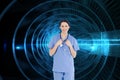 Smiling medical intern wearing a blue shortsleeve uniform