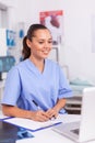 Smiling medical nurse writing notes Royalty Free Stock Photo