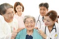 Smiling medical staff with old women Royalty Free Stock Photo