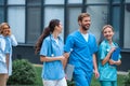 smiling medical students and lecturer walking on street Royalty Free Stock Photo