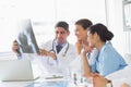 Smiling medical team analyzing xray Royalty Free Stock Photo