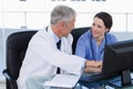 Smiling medical team working with a computer Royalty Free Stock Photo