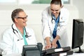 Smiling medical team working on computer Royalty Free Stock Photo