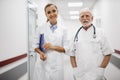 Smiling medical workers posing in hospital hallway Royalty Free Stock Photo