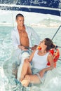 Man steering sailboat with girlfriend Royalty Free Stock Photo